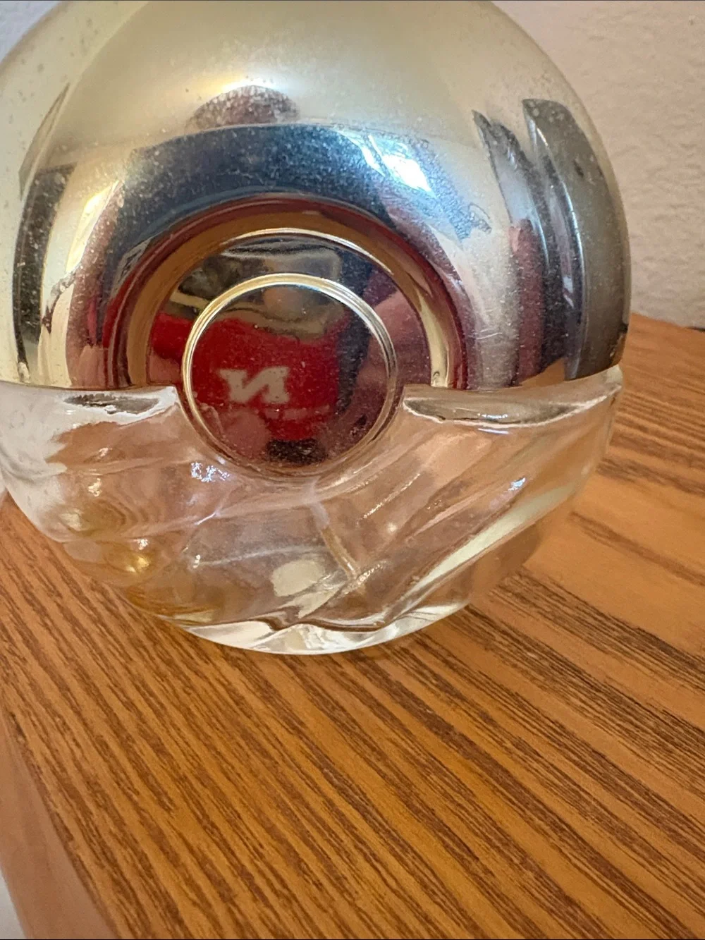 Avon Foxfire, empty, Round Silver-Tone Glass Decorative Bottle with Red Emblem